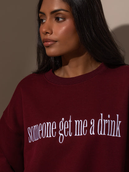 ["Need a Drink Sweatshirt ", " Burgundy ", " Model Image ", " Uncommon Lifestyle"]