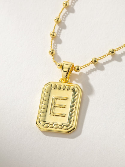["Sur Necklace ", " Gold E ", " Product Image ", " Uncommon James"]