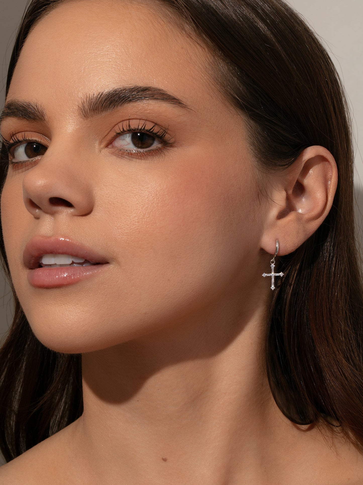 Bold Cross Huggie Earrings | Sterling Silver | Model Image | Uncommon James