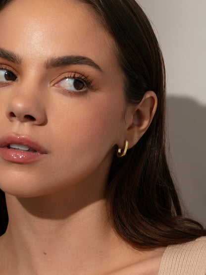 ["Oval Huggie Earrings ", " Gold ", " Model Image ", " Uncommon James"]