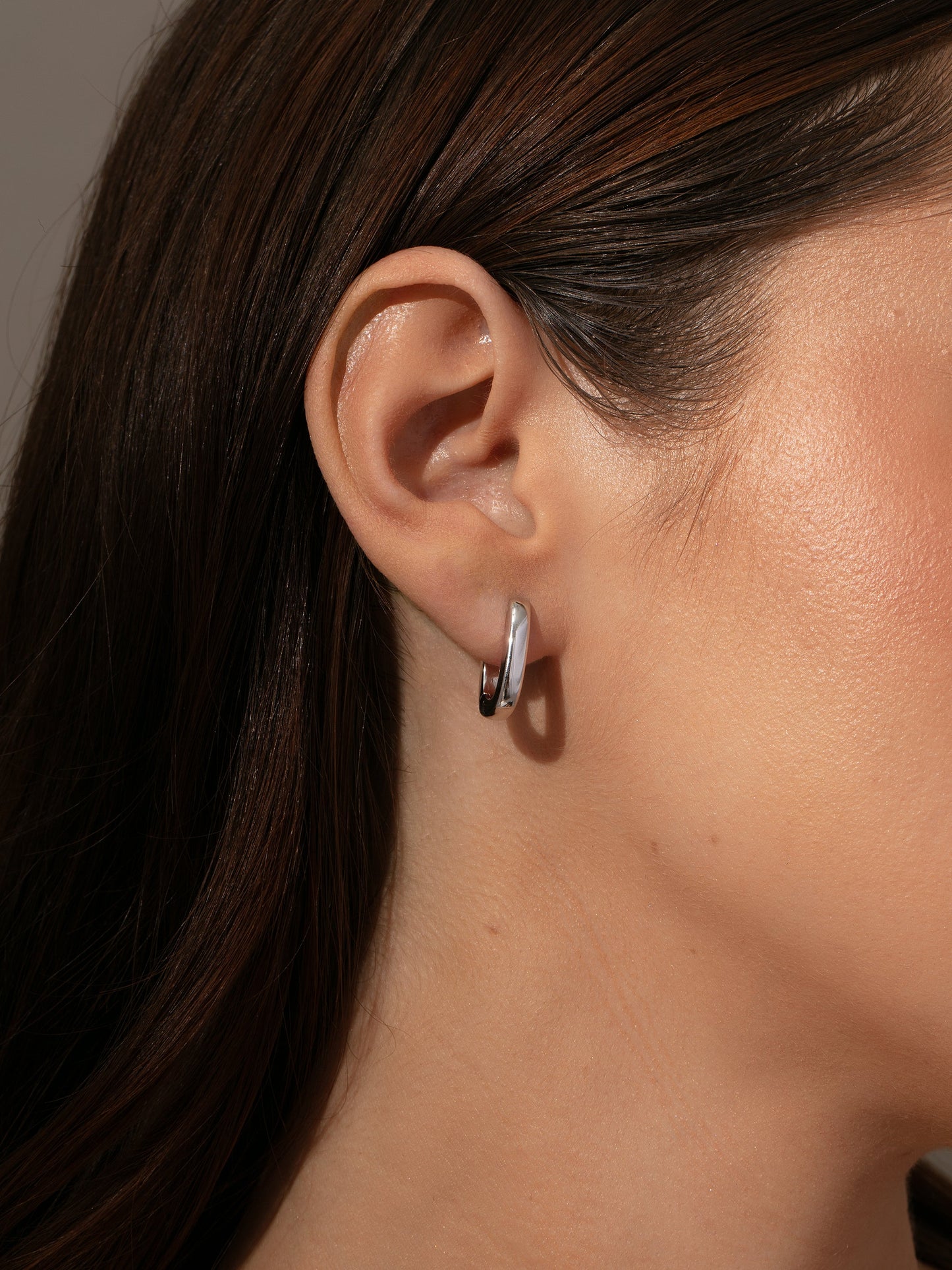 Oval Huggie Earrings | Silver | Model Image | Uncommon James