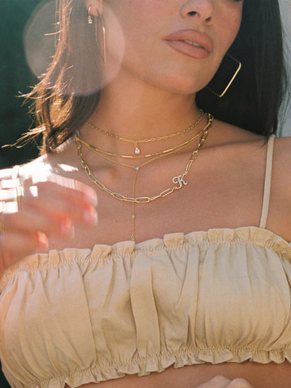 ["Cursive Initial Necklace ", " Gold ", " Model Image ", " Uncommon James"]