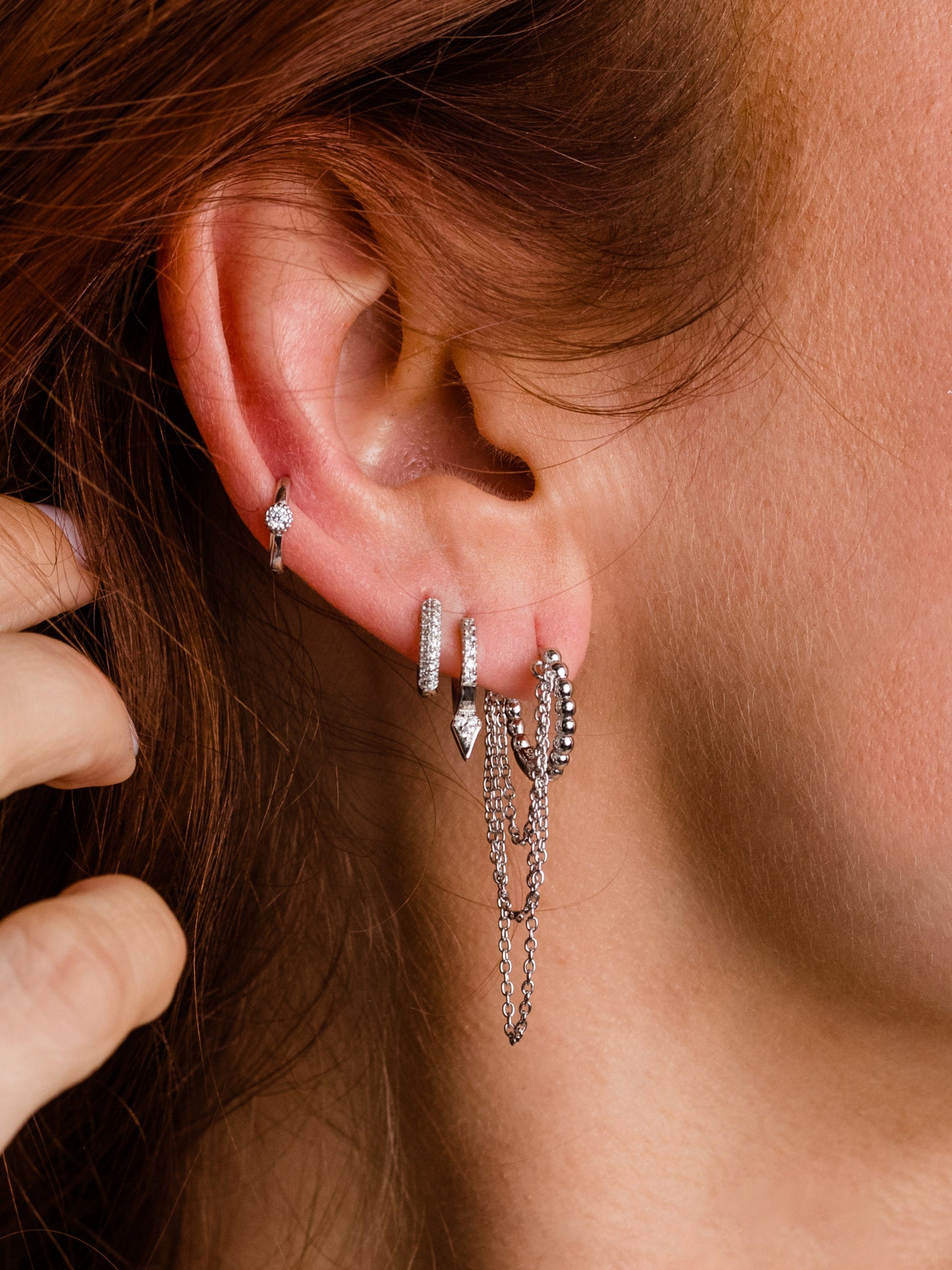 Tipping Point Pavé Huggie Earrings | Sterling Silver | Model Image 2 | Uncommon James