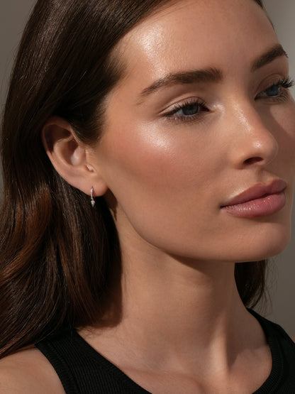 ["Tipping Point Pavé Huggie Earrings ", " Sterling Silver ", " Model Image ", " Uncommon James"]