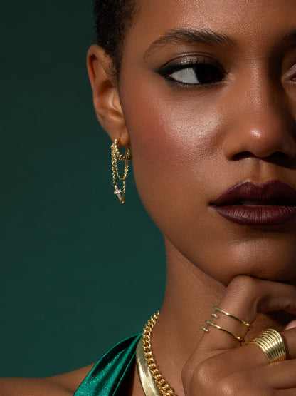 ["Cross and Chain Huggie Earrings ", " Gold ", " Campaign Image ", " Uncommon James"]