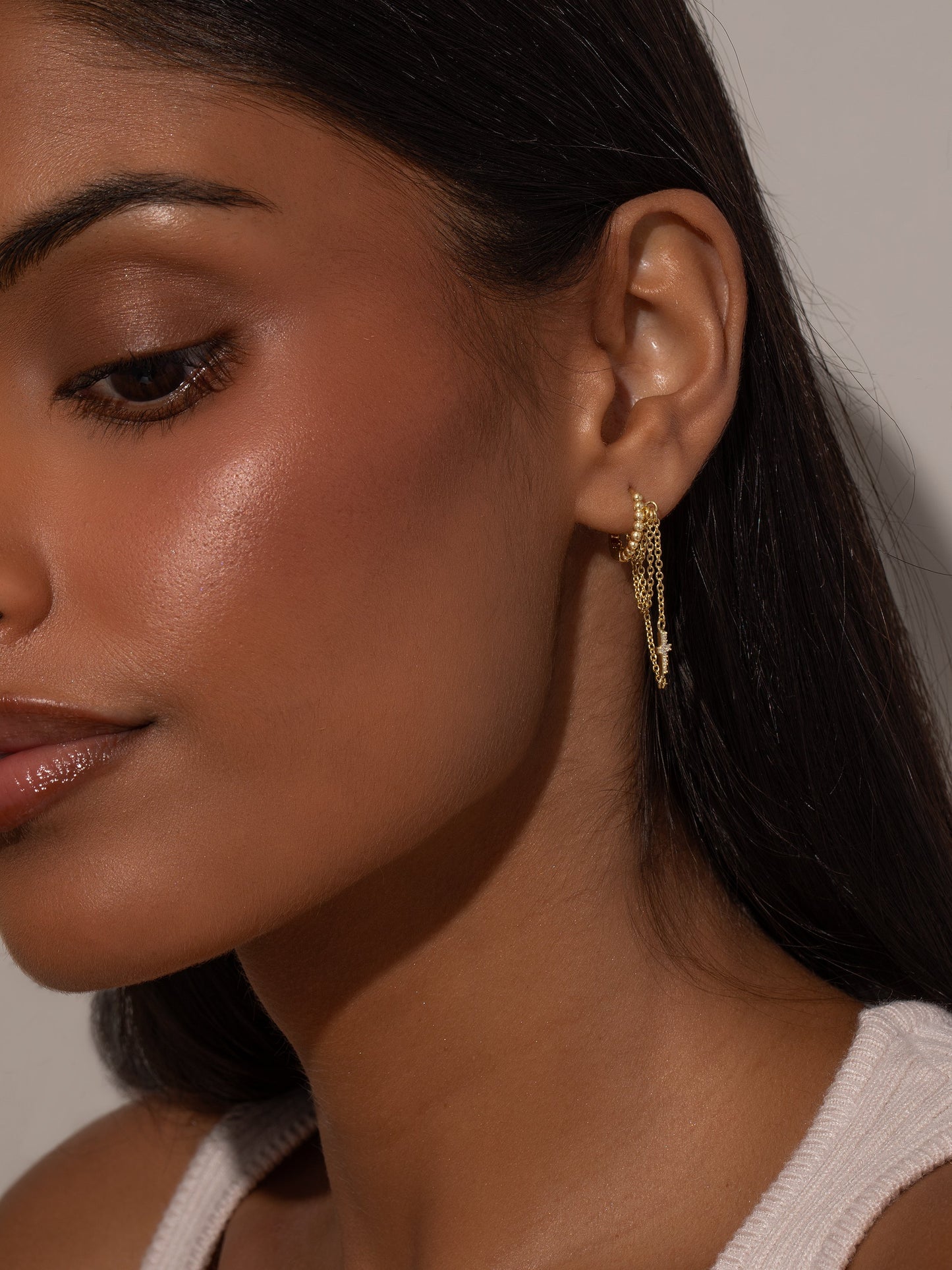 Cross and Chain Huggie Earrings | Gold | Model Image | Uncommon James