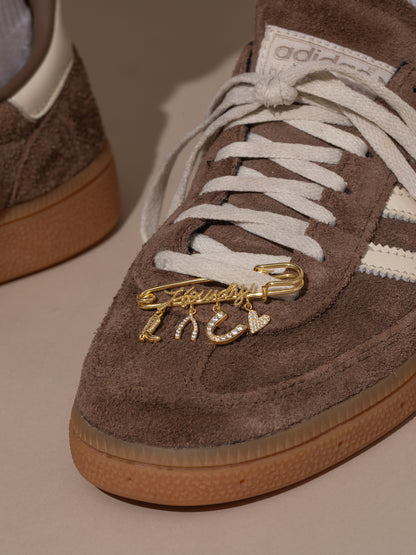 ["UJ x Rustler Howdy Pin ", " Gold ", " Model Image ", " Uncommon James"]