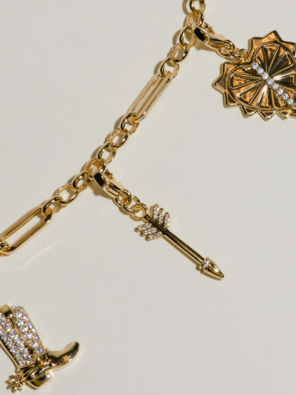 ["Arrow Charm ", " Gold ", " Flatlay Image ", " Uncommon James"]