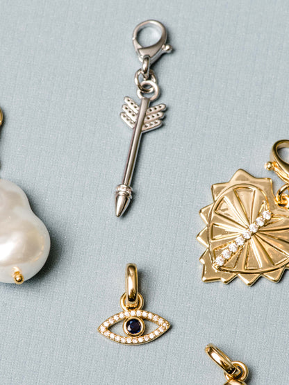 ["Arrow Charm ", " Silver ", " Flatlay Image ", " Uncommon James"]