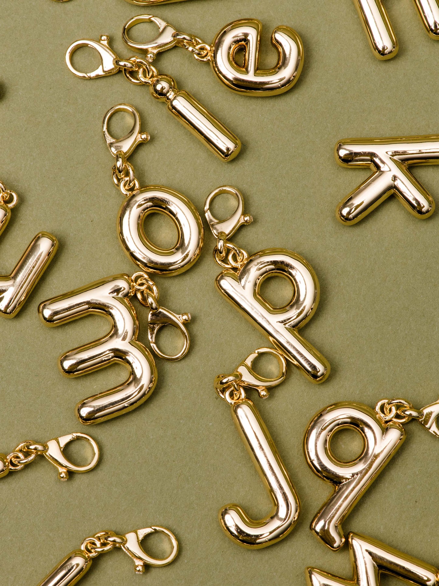 Bubble Letter Charm | Gold | Flatlay Image | Uncommon James