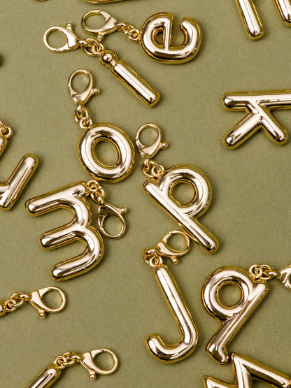 ["Bubble Letter Charm ", " Gold ", " Flatlay Image ", " Uncommon James"]