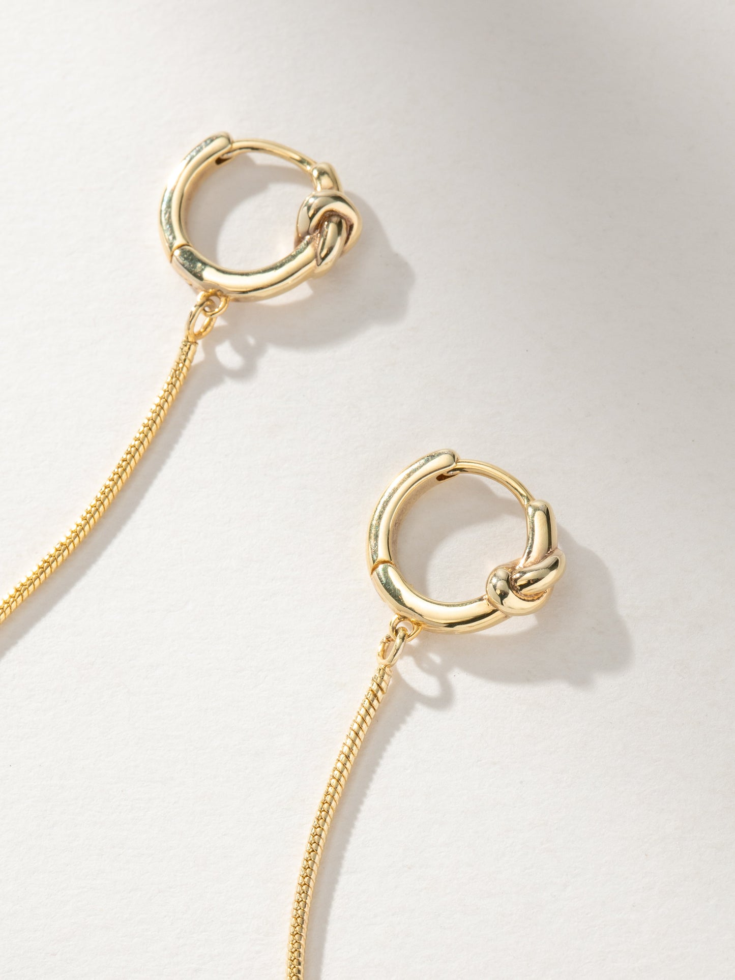 Forever Knot and Chain Huggie Earrings | Gold | Product Image | Uncommon James