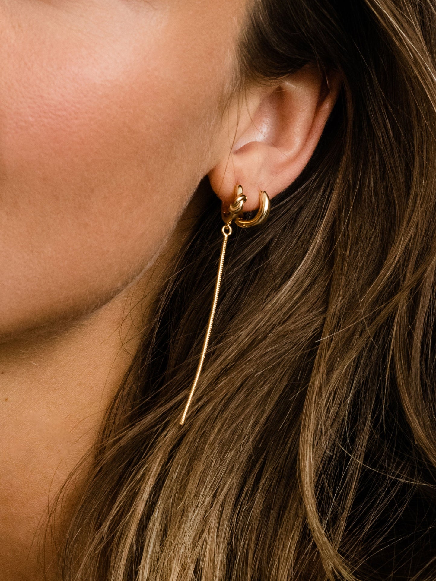 Forever Knot and Chain Huggie Earrings | Gold | Model Image | Uncommon James