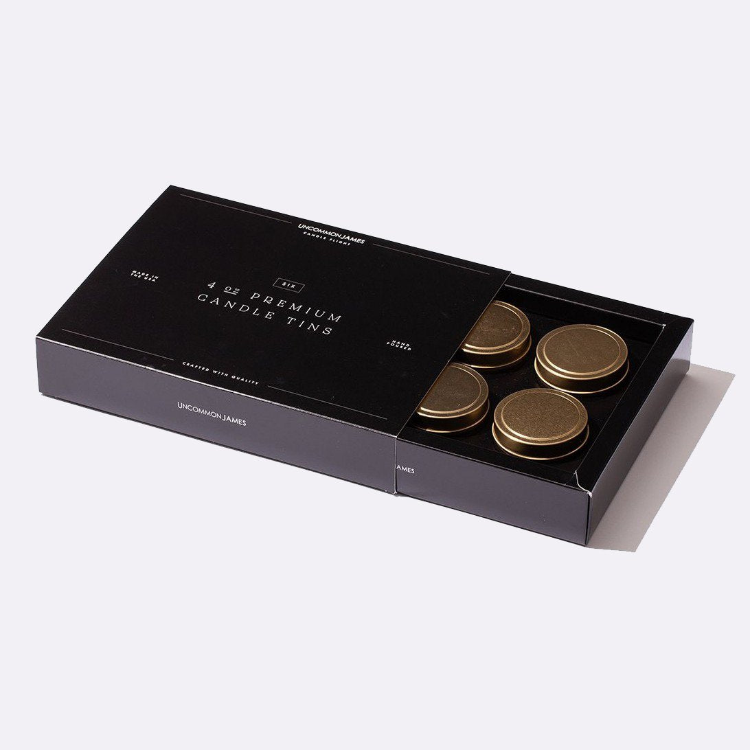 A black gift box of premium candle tins; 4oz candle gift set for holiday gifting