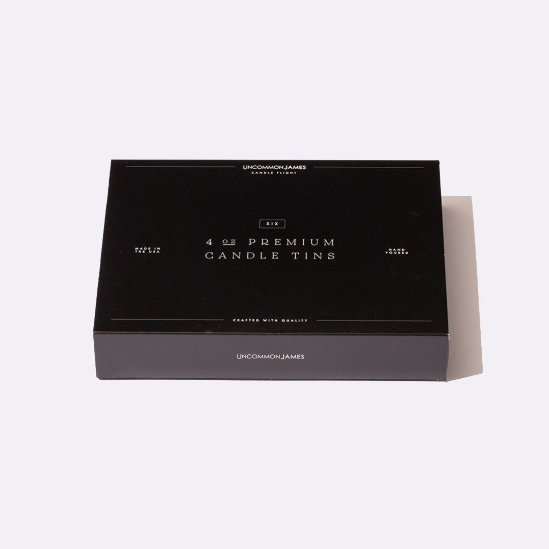 A black gift box of premium candle tins; 4oz candle gift set for holiday gifting